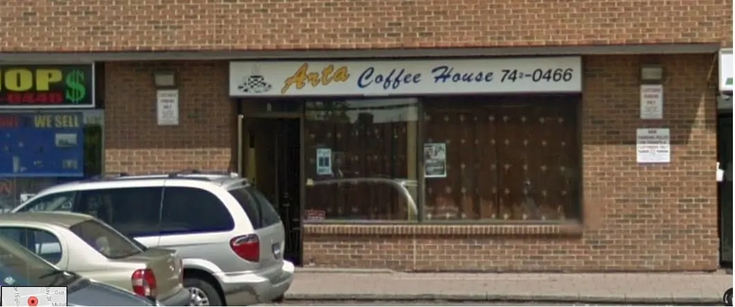 Arta Coffee House storefront sign on a brick plaza on McArthur Avenue